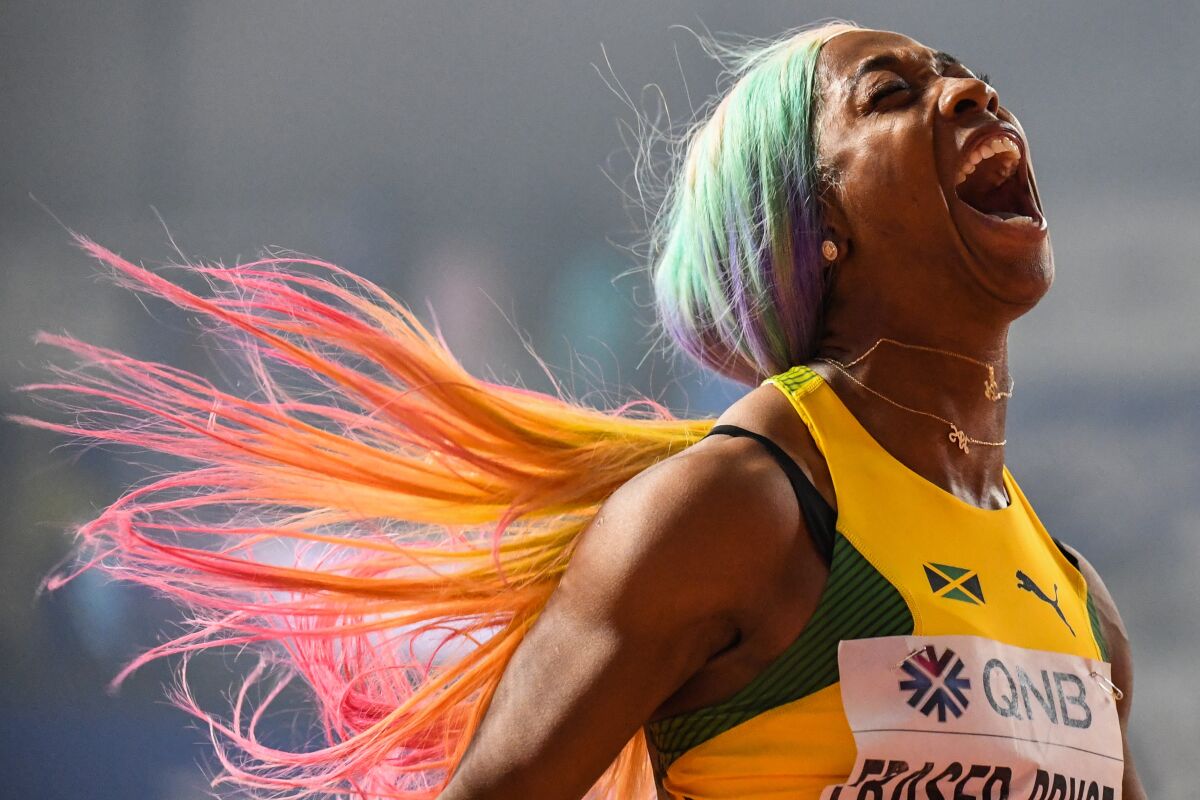 Jamaica's Shelly-Ann Fraser-Pryce celebrates after winning the women's 100 meters.