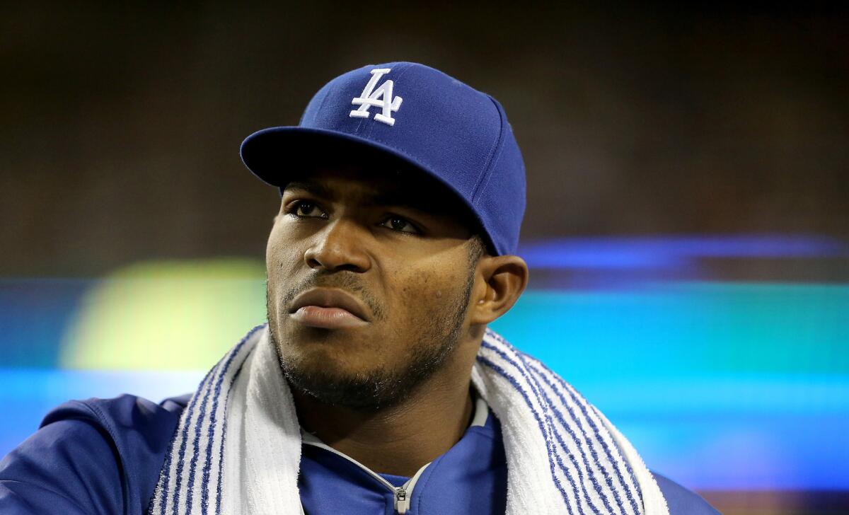 Dodgers outfielder Yasiel Puig watches the action from the dugout during a game last week.