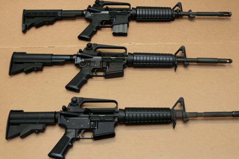 Three variations of the AR-15 assault rifle are displayed at the California Department of Justice in Sacramento, Calif.
