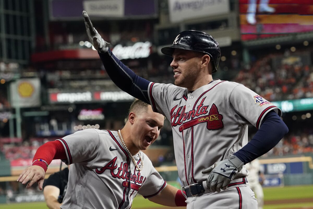 Freddie Freeman celebrates with Joc Pederson after hitting a home run.