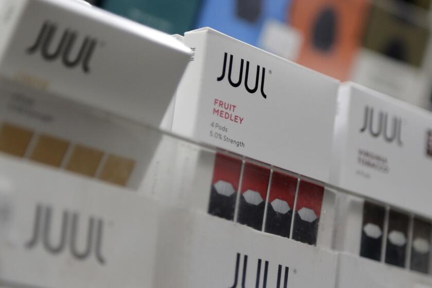 Juul products are displayed at a smoke shop in New York, Thursday, Dec. 20, 2018. Altria, one of the world's biggest tobacco companies, is spending nearly $13 billion to buy a huge stake in the vape company Juul as cigarette use continues to decline. (AP Photo/Seth Wenig)