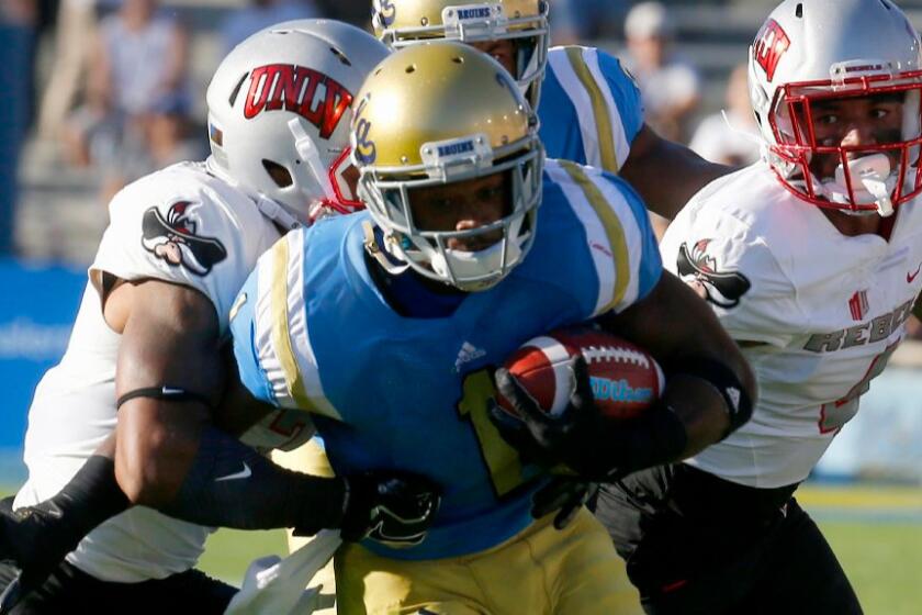 UCLA receiver Ishmael Adams is tackled during the Bruins' 42-21 victory over UNLV on Sept. 10.