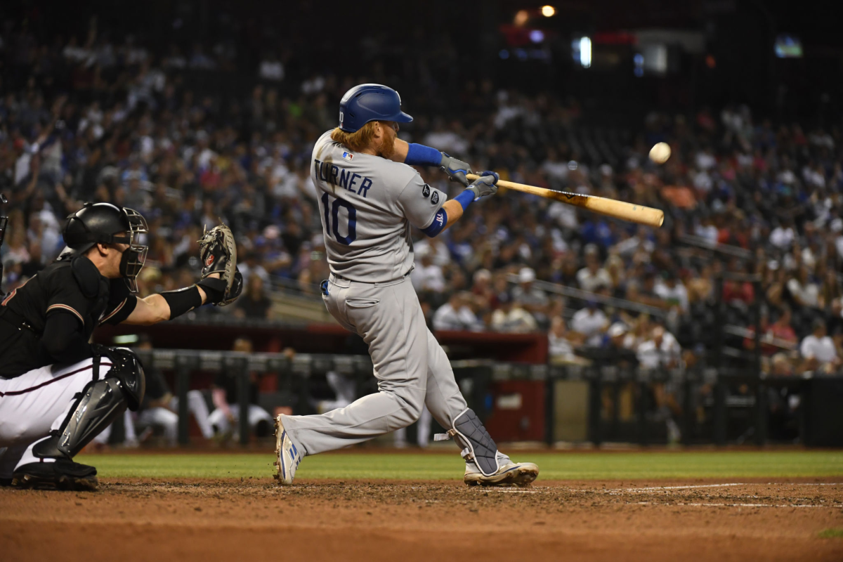 The Dodgers' Justin Turner hits a go-ahead two-run homer during the seventh inning Saturday.