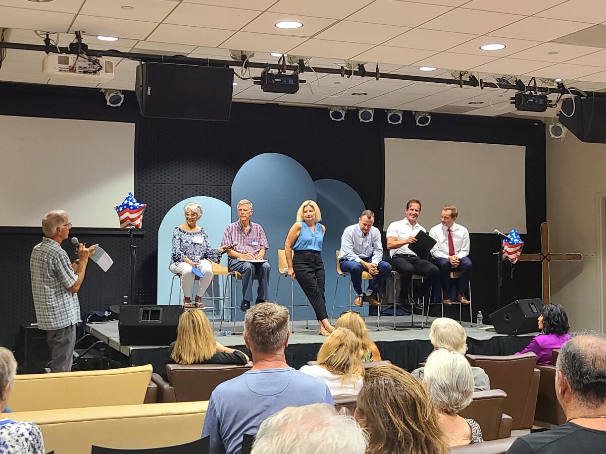 Six of the eight Newport Beach City Council candidates listen.