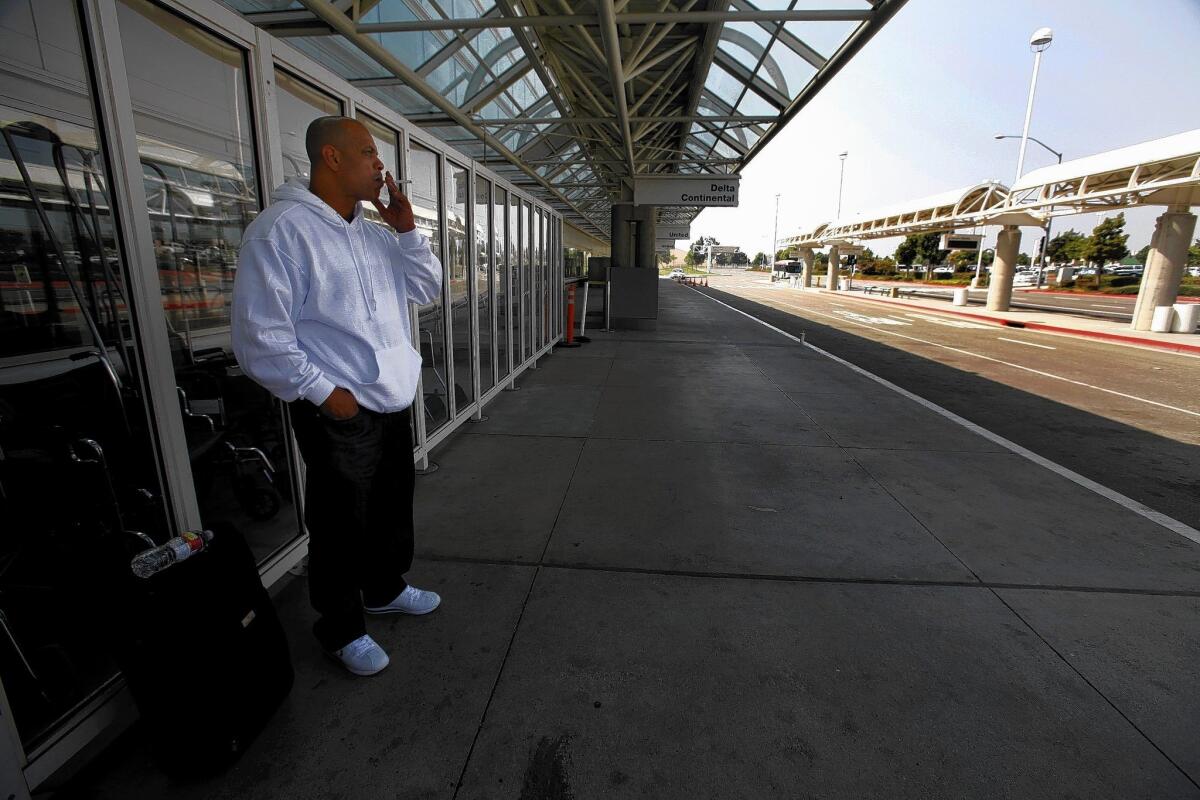A passenger has a smoke before his flight at the LA/Ontario International Airport. The number of annual passengers using LA/Ontario has plunged from 7.2 million in 2007 to 3.97 million today.