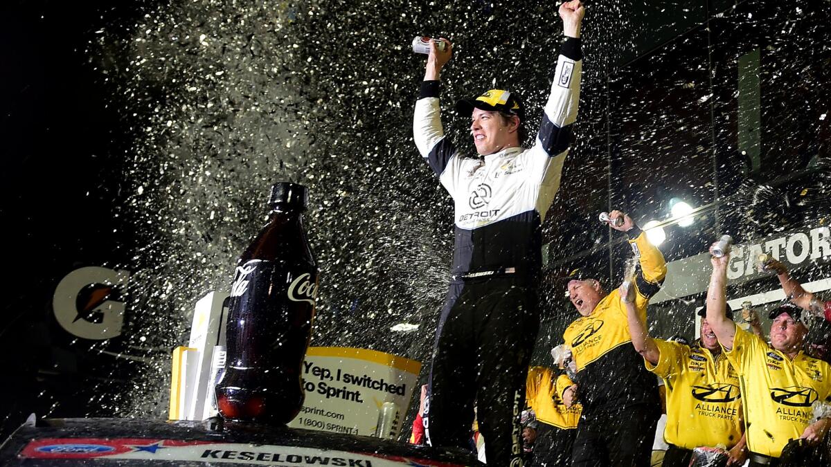 NASCAR driver Brad Keselowski and his crew celebrate after winning the Coke Zero 400 on Saturday night at Daytona International Speedway.