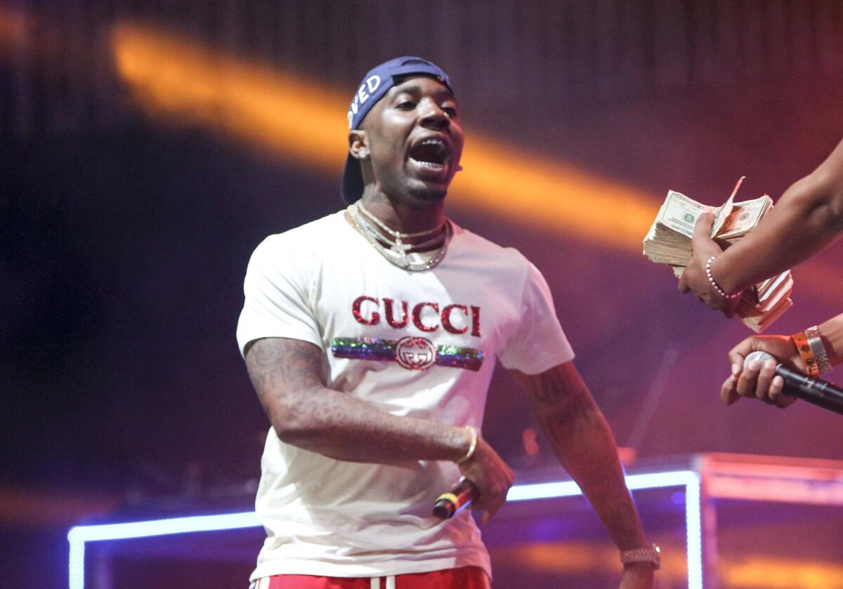 YFN Lucci in a white Gucci T-shirt performs onstage