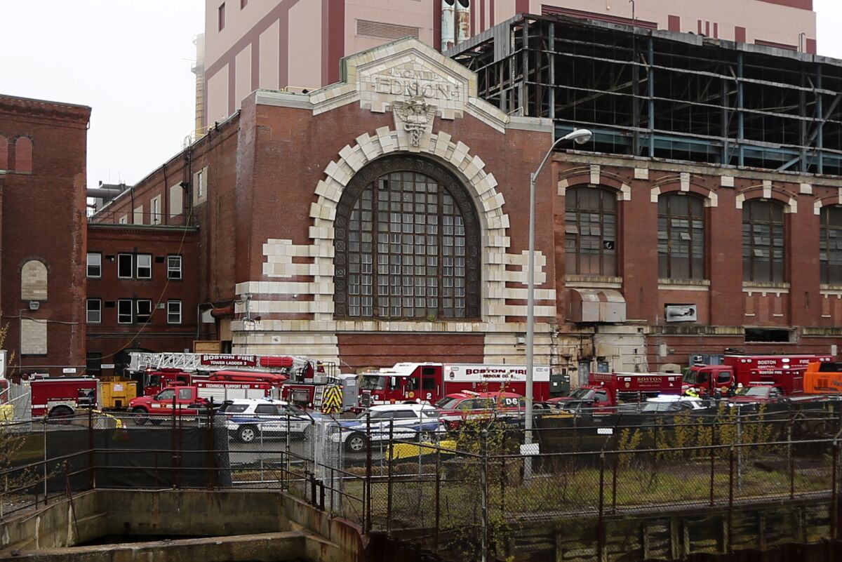 Boston fire, police and emergency services vehicles surround a construction site outside a former power plant, where workers were injured, Wednesday May 4, 2022, in the South Boston neighborhood of Boston. At least three people were injured, and there were reports of multiple people trapped during a partial collapse at a Boston construction site on Wednesday afternoon, authorities said. (Stuart Cahill/The Boston Herald via AP)