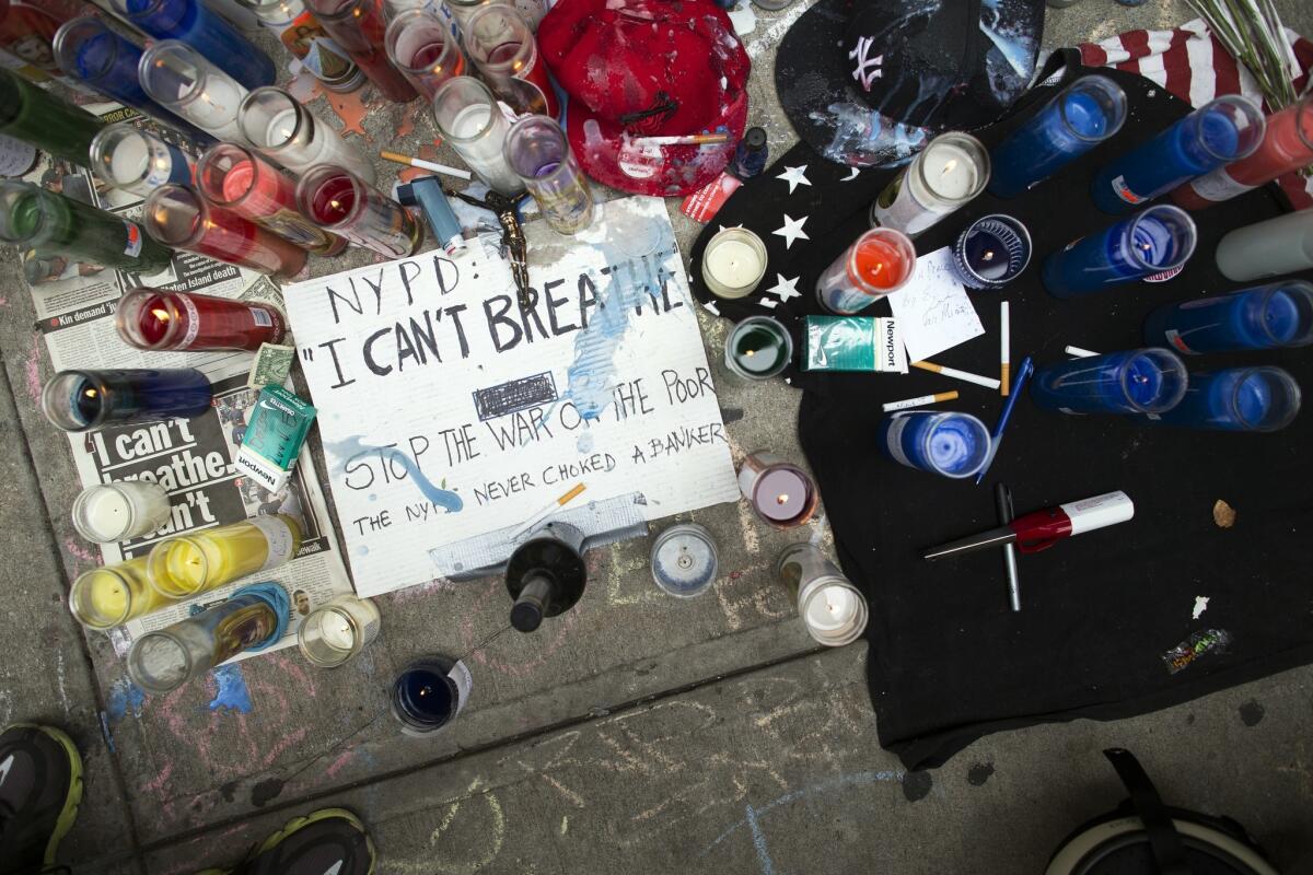 A memorial for Eric Garner rests on the pavement near the site of his death, Saturday, July 19, 2014, in the Staten Island borough of New York.