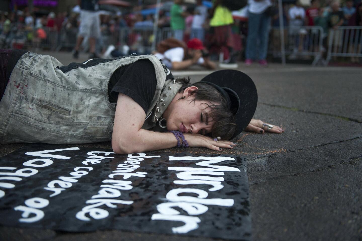 A protester wanting only to be identified as Johnny participates in a die-in to raise awareness for transgender rights at the San Diego Pride Parade.
