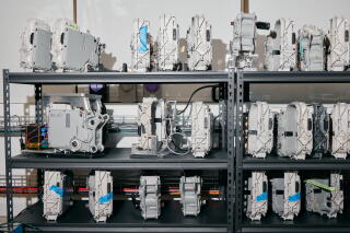 A rack of motor and transmission components for e-bikes.