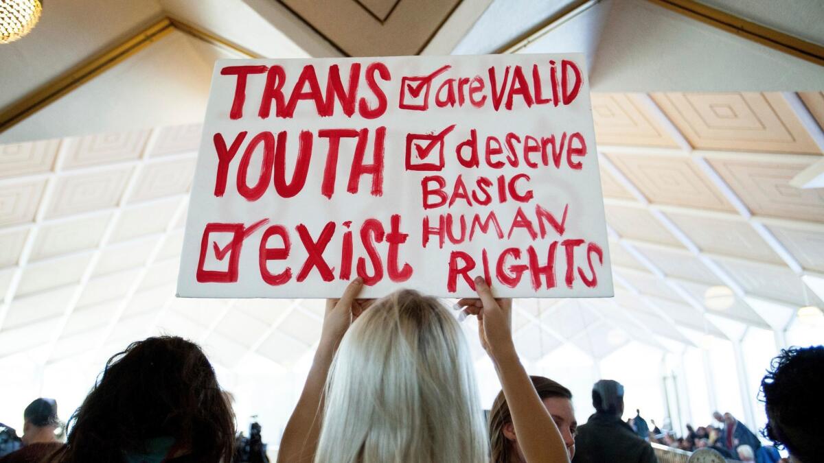 A protester holds a sign in favor of repealing North Carolina's HB2 "bathroom bill" in Raleigh on Dec. 21, 2016.