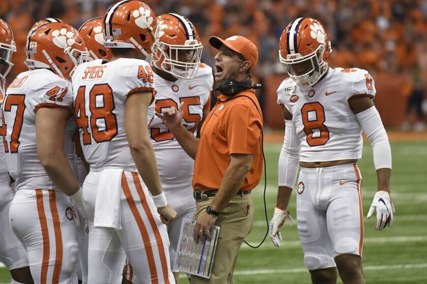 Clemson coach Dabo Swinney talks to his players against Syracuse during the first half of an NCAA college football game Saturday, Sept. 14, 2019, in Syracuse, N.Y. (AP Photo/Steve Jacobs)