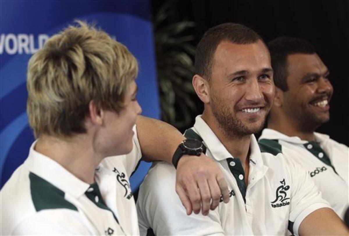 Australian rugby player James O'Connor left, leans on teammate Quade Cooper center, as they joke around during a press conference in Wellington, New Zealand, Wednesday, Oct. 5, 2011. Australia will play South Africa in the Rugby World Cup quarterfinals on Sunday Oct. 9.(AP Photo/Rob Griffith)