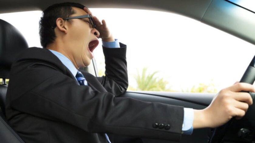 Exhausted driver yawning and driving car.