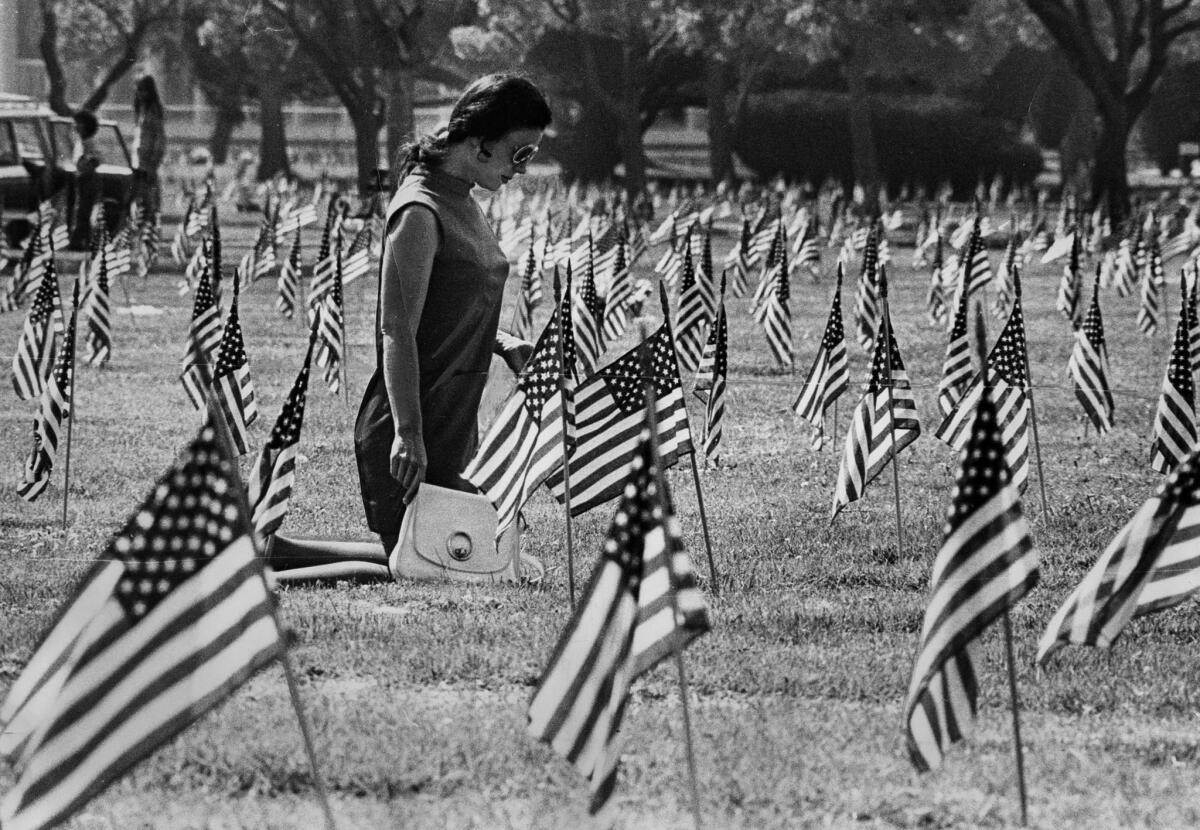 May 28, 1973: On Memorial Day, Juanita Lane kneels at the grave of her son at the Veterans Cemetery in West Los Angeles.