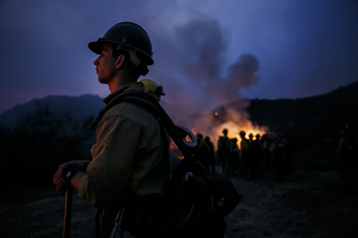 Firefighters monitor the embers in the air as they conduct a burn-out operation in El Capitan Canyon.