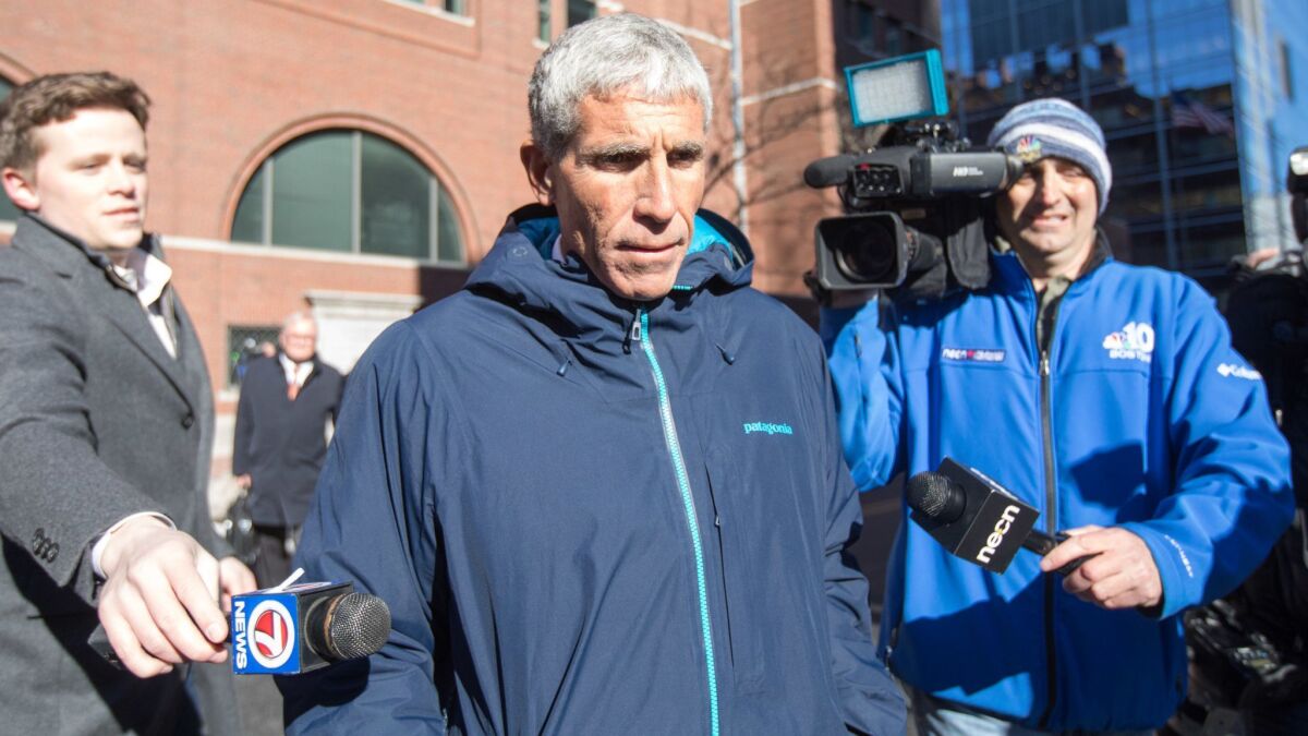 William "Rick" Singer leaves Boston federal court after pleading guilty to racketeering, money laundering, obstruction of justice and conspiracy to defraud the United States on Tuesday.