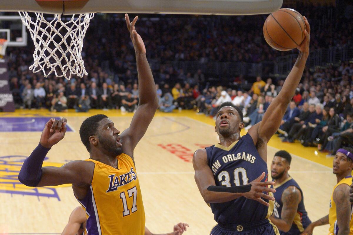 New Orleans Pelicans guard Norris Cole, right, shoots as Lakers center Roy Hibbert tries to block his shot during a Jan. 12 game at Staples Center.