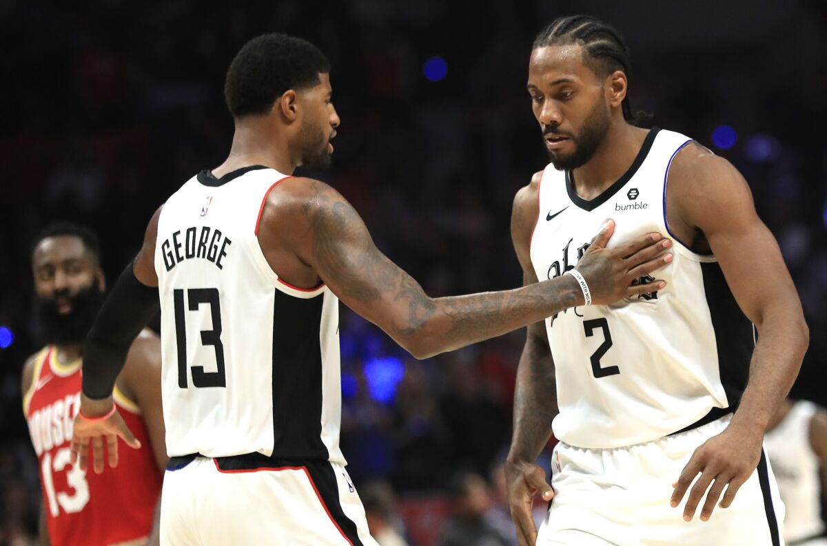 All-Star forwards Paul George and Kawhi Leonard celebrate during a Clippers game against the Rockets last season.