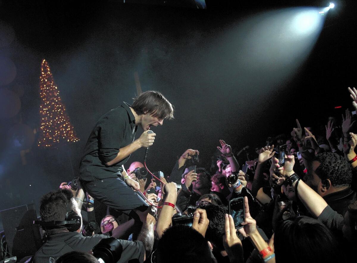 Thomas Mars of the band Phoenix at the Almost Acoustic Christmas show last month at Shrine Auditorium, where the crowd talked, texted and shot photos.