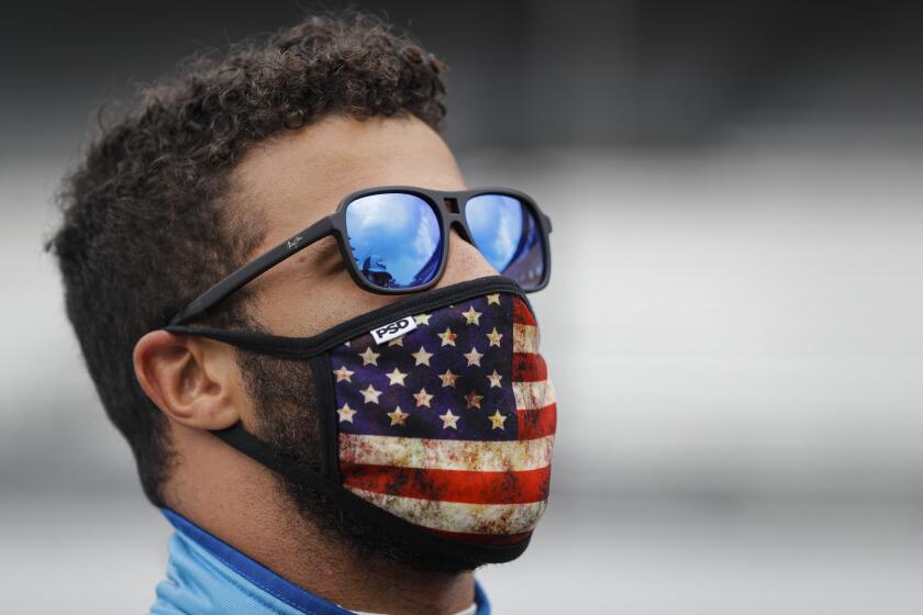 Bubba Wallace checks the sky during a weather delay before a NASCAR Cup Series auto race at Indianapolis Motor Speedway in Indianapolis, Sunday, July 5, 2020. (AP Photo/Darron Cummings)