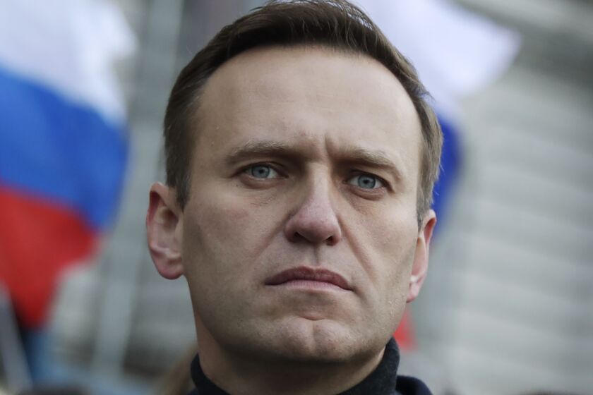 FILE - In this file photo taken on Saturday, Feb. 29, 2020, Russian opposition activist Alexei Navalny takes part in a march in memory of opposition leader Boris Nemtsov in Moscow, Russia. The German hospital treating Russian dissident Alexei Navalny says tests indicate that he was poisoned. The Charité hospital said in a statement Monday, Aug. 24, 2020 that the team of doctors who have been examining Navalny since he was admitted Saturday have found the presence of “cholinesterase inhibitors” in his system. Cholinesterase inhibitors are a broad range of substances that are found in several drugs, but also pesticides and nerve agents. (AP Photo/Pavel Golovkin, File)