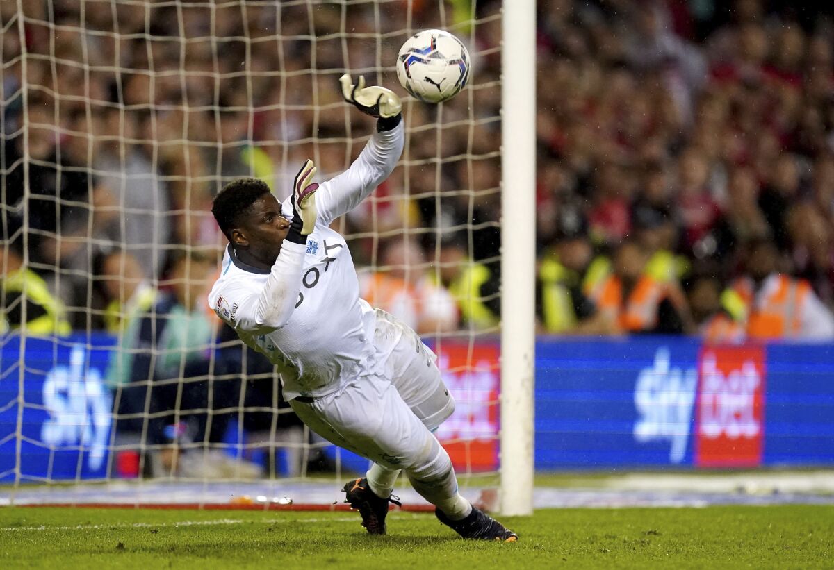 Nottingham Forest goalkeeper Brice Samba saves a penalty kick by Sheffield United's Oliver Norwood during a shootout in a Sky Bet Championship play-off semi-final, second leg soccer match against Nottingham Forest at the City Ground, Nottingham, England, Tuesday May 17, 2022. (Zac Goodwin/PA via AP)