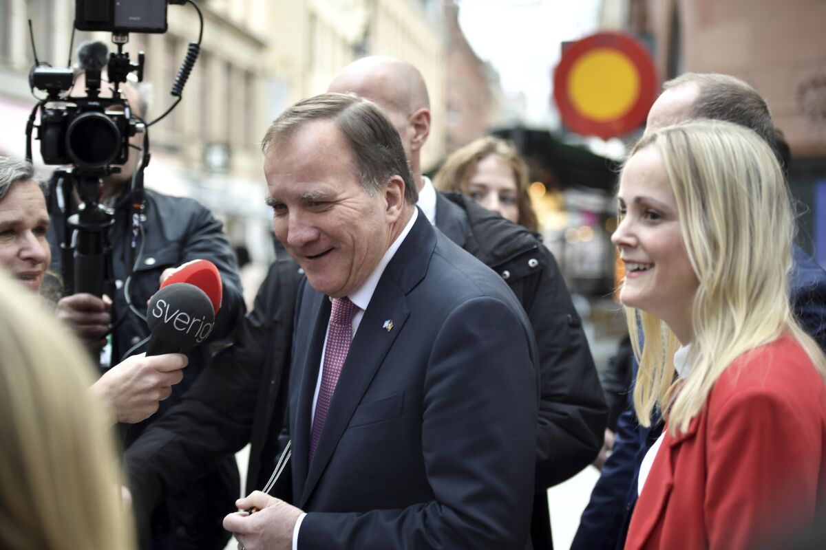 Swedish Prime Minister Stefan Lofven is surrounded by journalists as he walks from the government headquarters to the parliament to hand in his resignation to the speaker of parliament in Stockholm, Sweden, Wednesday, Nov. 10, 2021. (Duygu Getrien/TT via AP)
