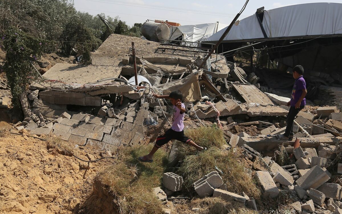 Palestinians inspect the rubble of a house after it was hit by an Israeli missile strike in Rafah, southern Gaza Strip, on Sunday. The strikes targeted what the army said were militant sites after rockets and mortar shells were fired at Israel from the Gaza Strip over the weekend.