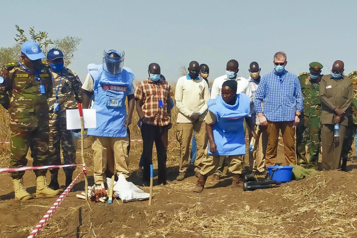 Members of the United Nations Mine Action Service (UNMAS) demonstrate the procedures they use to detect land mines, in Gondokoro on the outskirts of the capital Juba, South Sudan Wednesday, Jan. 26, 2022. As South Sudan struggles for peace, it's still cleaning up the deadly threat posed by thousands of land mines from previous conflict decades ago. (AP Photo/Deng Machol)