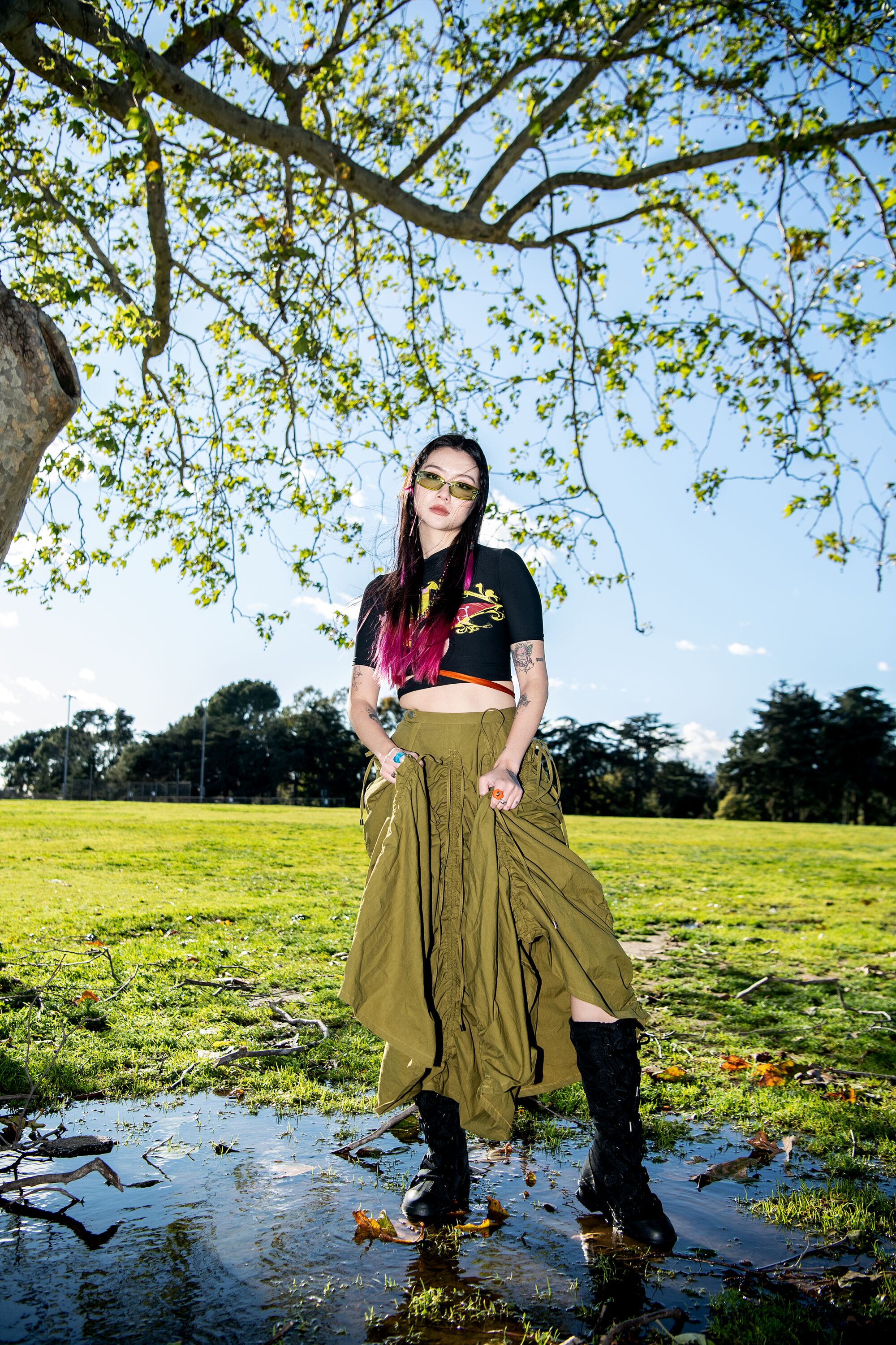 Qian wears Acne Studios boots, a Phlemuns skirt, Ottolinger top, a Rui necklace and Bonnie Clyde glasses.