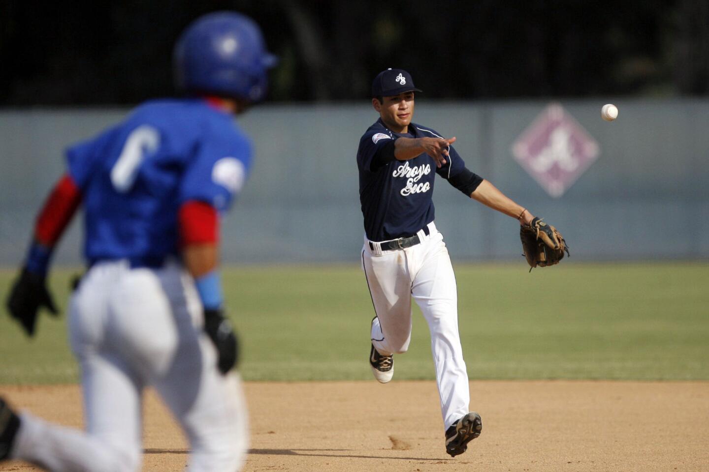 Arroyo Seco's David Olmedo-Barrera passes the ball to first base during a game against Puerto Rico, which took place at Major League Baseball Urban Youth Academy in Compton on Thursday, August 3, 2012.
