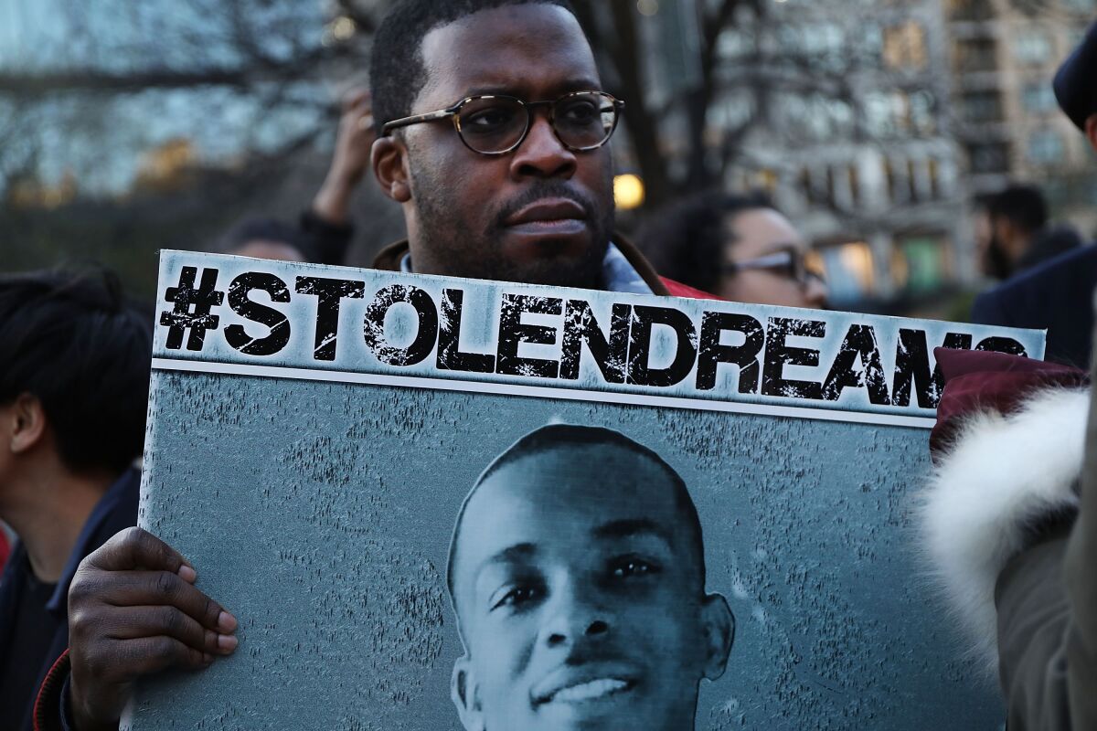 People attend a vigil for Stephon Clark on the anniversary of the assassination of Dr. Martin Luther King on April 4, 2018.