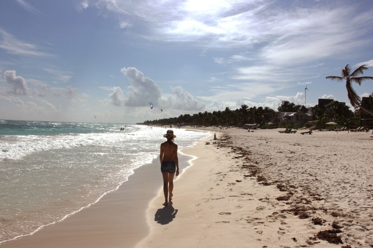 A woman walks along the beach in Tulum, Mexico. Travel from the U.S. to Mexico hit a record high of 25.9 million visitors in 2014, a 24% increase from 2013, according to the U.S. Department of Commerce.