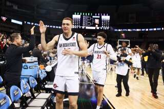 Spokane, WA - March 24: San Diego State forward Elijah Saunders (25) gives out high fives after the Aztecs beat Yale during the second round of the NCAA Tournament at Spokane Veterans Memorial Arena on Sunday, March 24, 2024 in Spokane, WA. (Meg McLaughlin / The San Diego Union-Tribune)