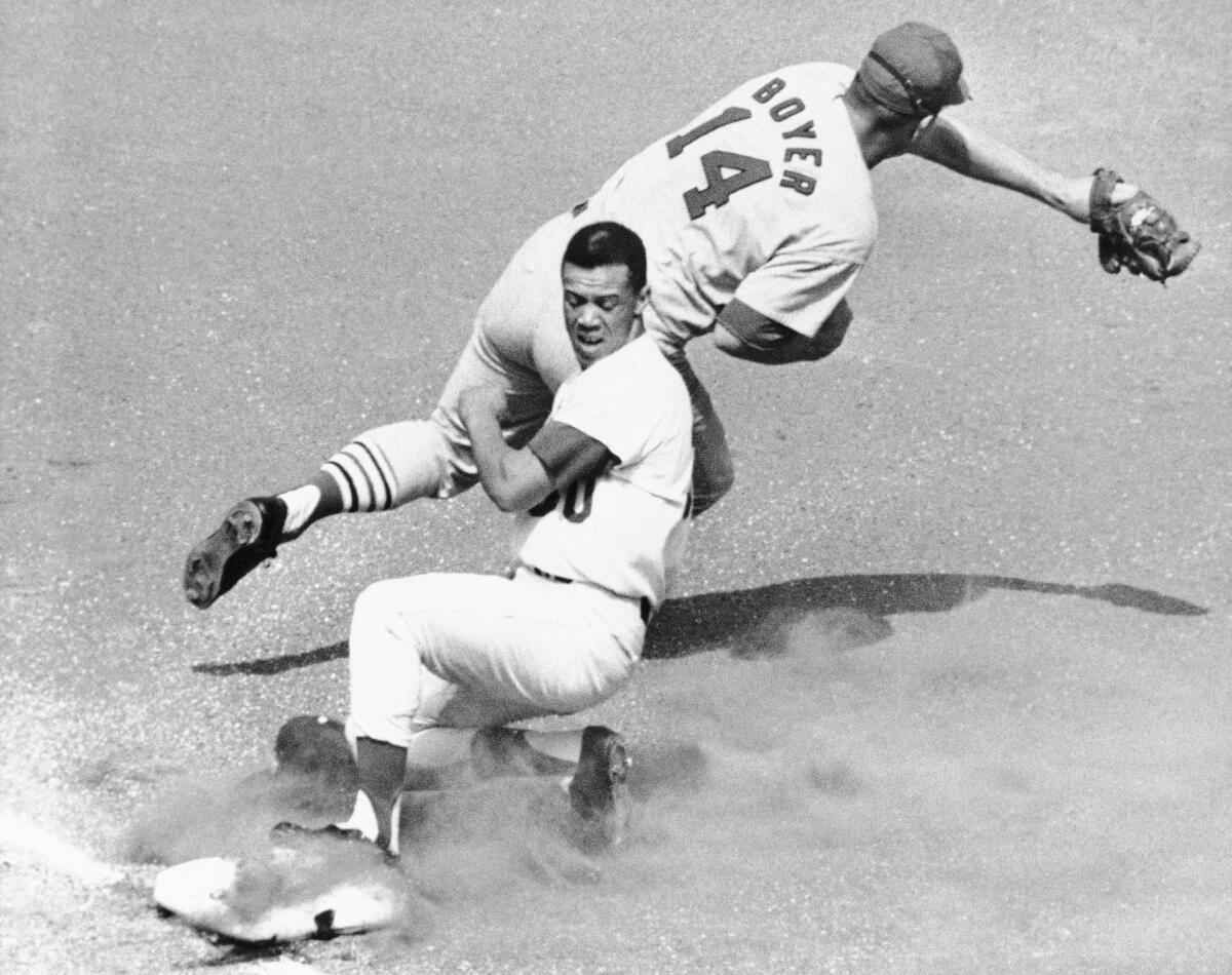 Maury Wills is safe at third as St. Louis' Ken Boyer takes the throw during a game in 1965.