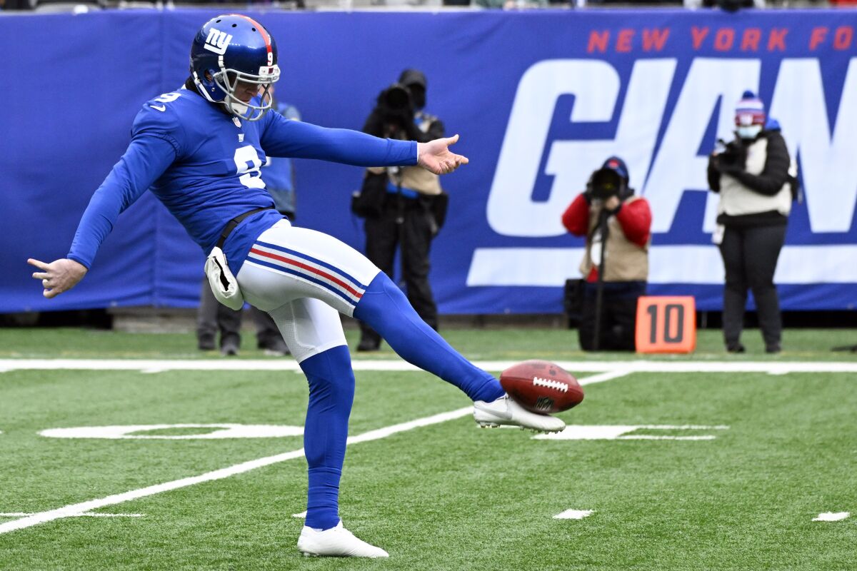 FILE - New York Giants punter Riley Dixon (9) punts the ball during the second quarter of an NFL football game against the Washington Football Team on Jan. 9, 2022, in East Rutherford, N.J. Dixon joined the Super Bowl champion Los Angeles Rams on Tuesday, April 5, 2022, after spending the past four seasons with the New York Giants, (AP Photo/Bill Kostroun, File)
