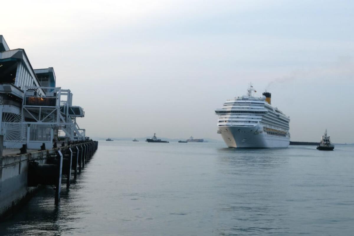 The Costa Fortuna cruise ship approaches the Marina Bay Cruise Center Singapore on Tuesday.