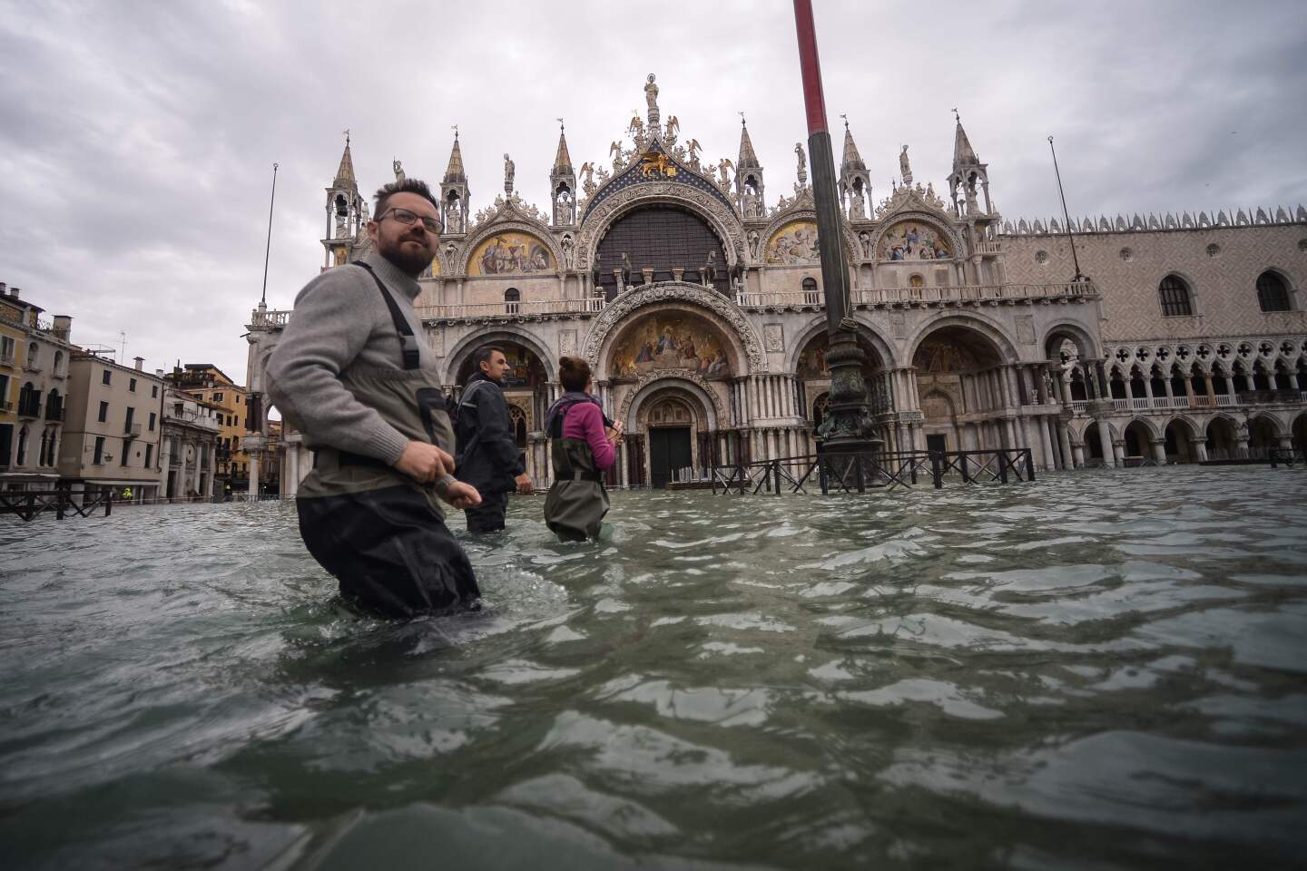A general view shows people walking across the flooded St. Mark's Square, by St. Mark's Basilica on November 15, 2019 in Venice, two days after the city suffered its highest tide in 50 years. - Flood-hit Venice was bracing for another exceptional high tide on November 15, as Italy declared a state of emergency for the UNESCO city where perilous deluges have caused millions of euros worth of damage. (Photo by Filippo MONTEFORTE / AFP) (Photo by FILIPPO MONTEFORTE/AFP via Getty Images) ** OUTS - ELSENT, FPG, CM - OUTS * NM, PH, VA if sourced by CT, LA or MoD **