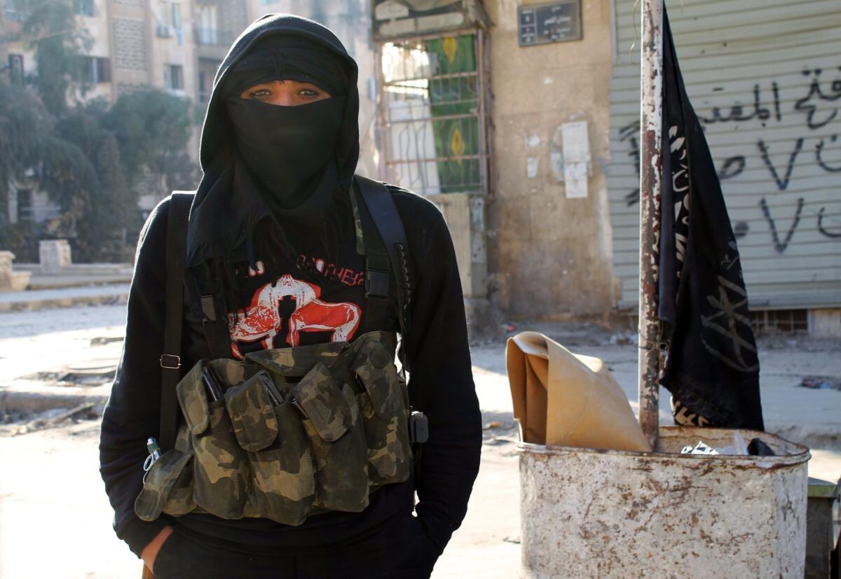 A member of the militant group Al Nusra Front stands in a street in the northern Syrian city of Aleppo last month.