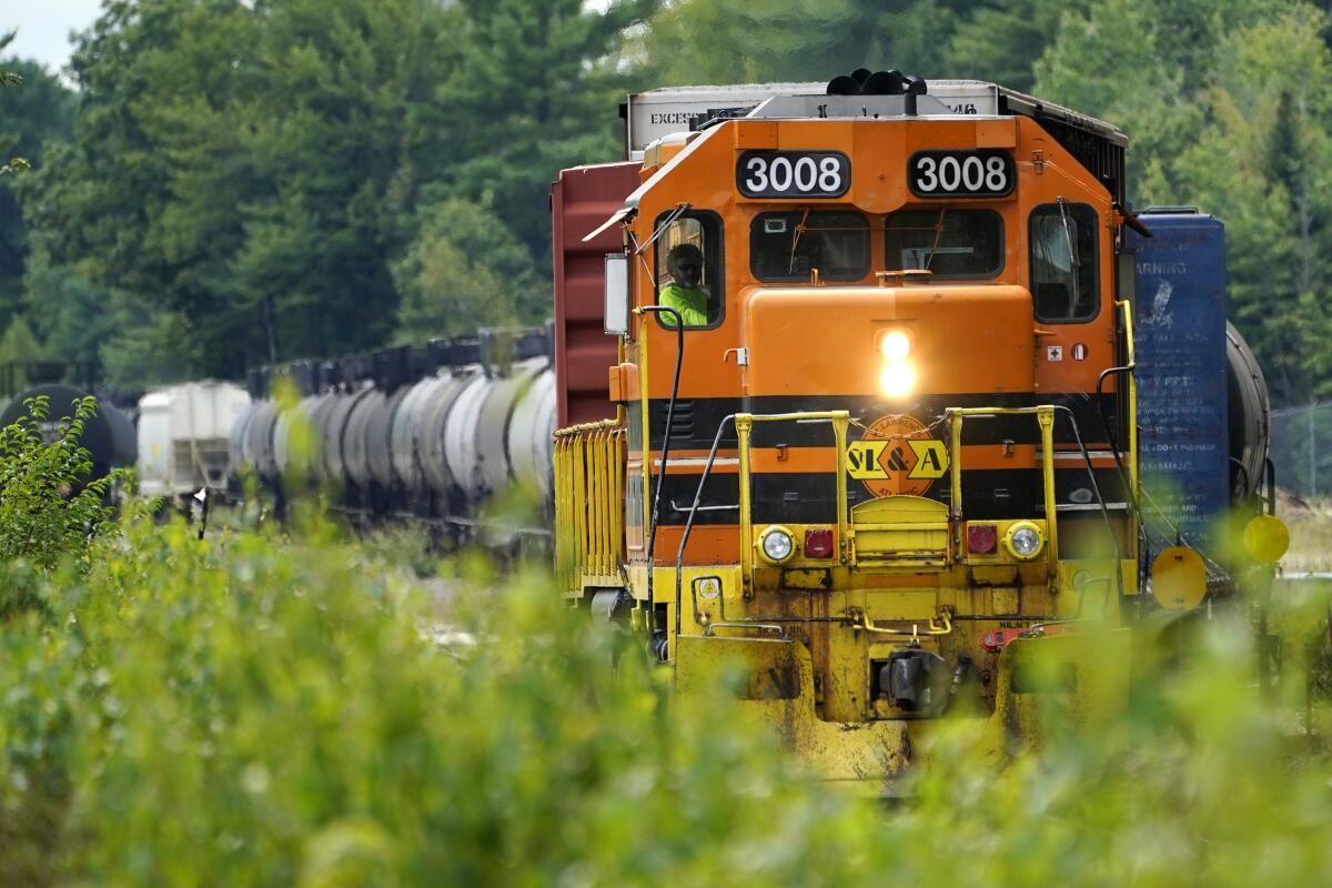 A St. Lawrence & Atlantic freight train travels Wednesday, Sept. 7, 2022, in Auburn, Maine. A proposed Boston-to-Montreal passenger train would travel through Maine on tracks north of Portland currently used only by freight trains. (AP Photo/Robert F. Bukaty)
