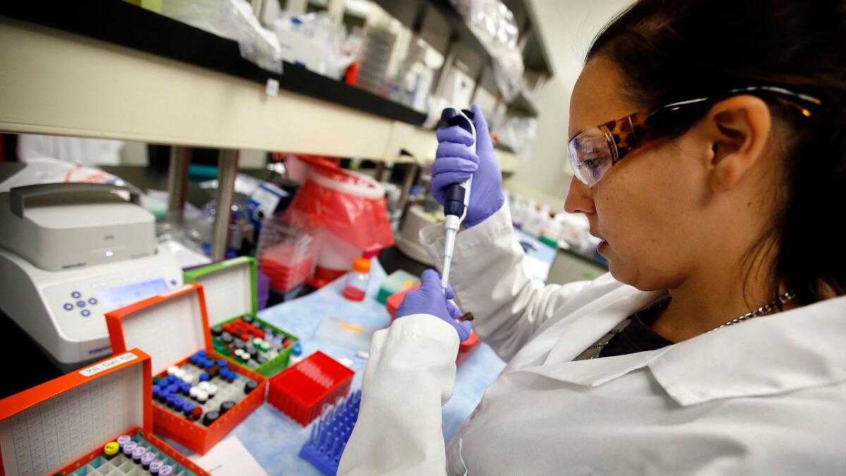 A Kite Pharma scientist sets up samples for an experiment at the Santa Monica facility in 2015.