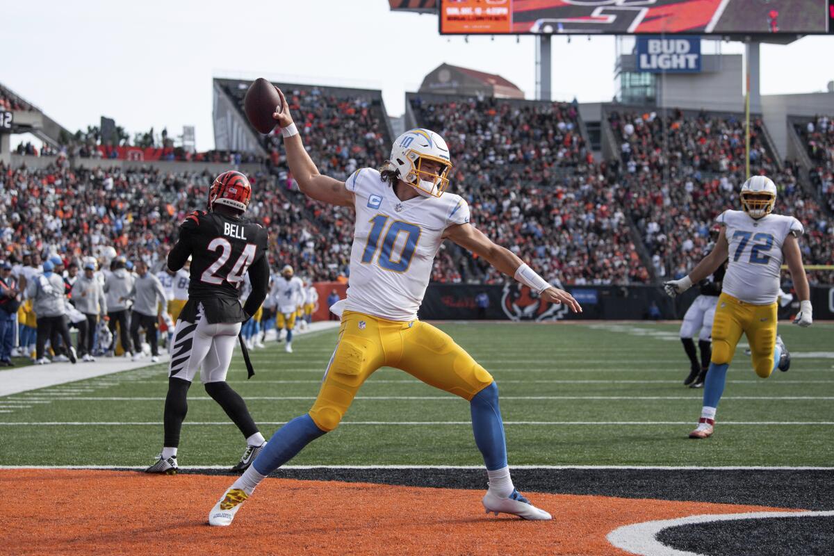 Chargers quarterback Justin Herbert spikes the football after his two-point conversation catch against the Bengals.