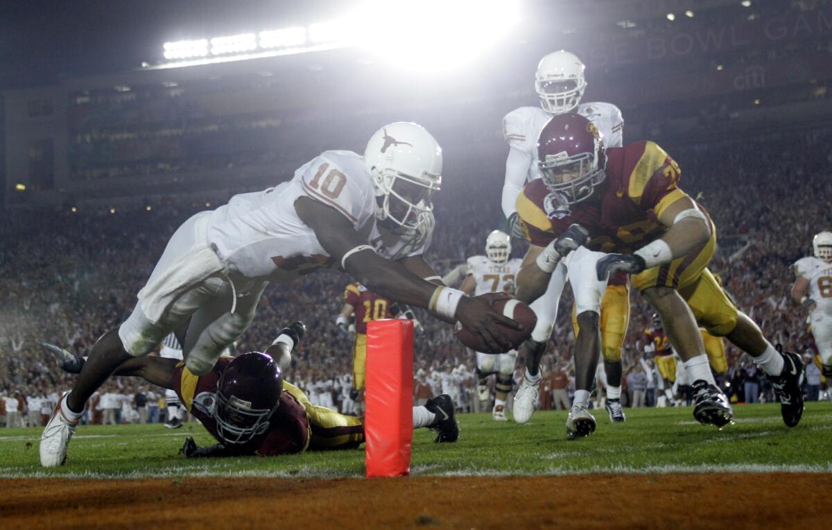 Texas quarterback Vince Young reaches the ball across the end zone for one of his three rushing touchdowns against USC in the BCS championship game at the Rose Bowl on Jan 4, 2006.