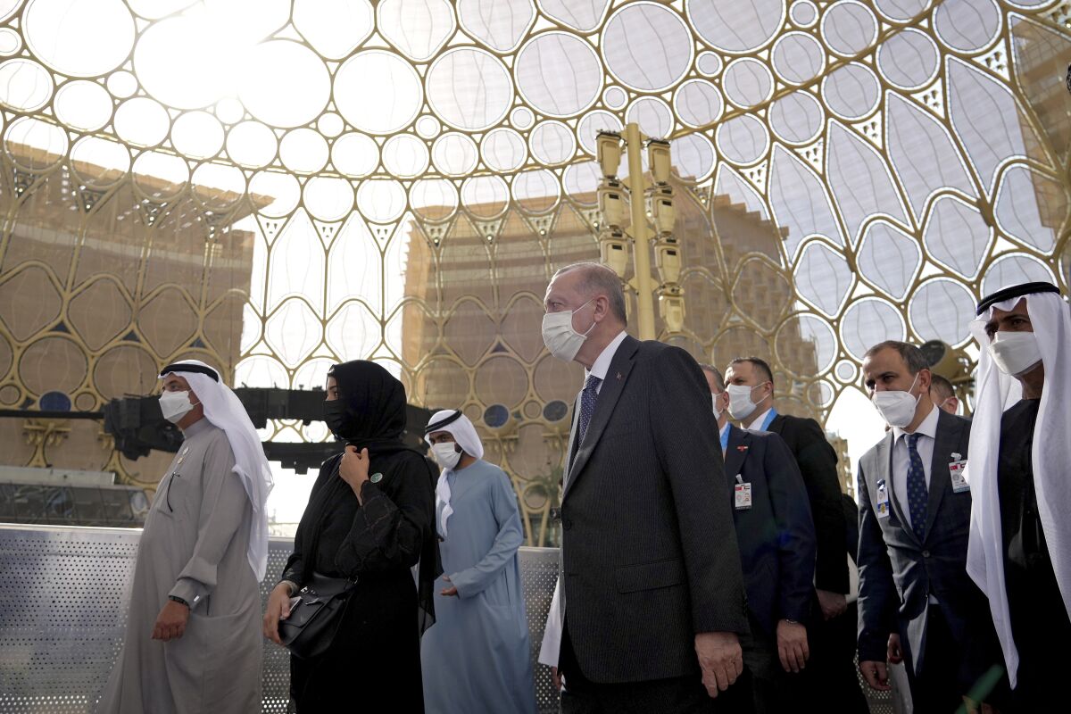 Turkish President Recep Tayyip Erdogan, center, visits the Dubai Expo 2020 for a Turkish national day ceremony, in Dubai, United Arab Emirates, Tuesday, Feb. 15, 2022. Erdogan spent his second day in the once adversarial country mending relations and deepening commercial ties. The new page in UAE-Turkey relations points to a wider reset in regional strategies following a decade of strained ties and proxy wars. (AP Photo/Ebrahim Noroozi)