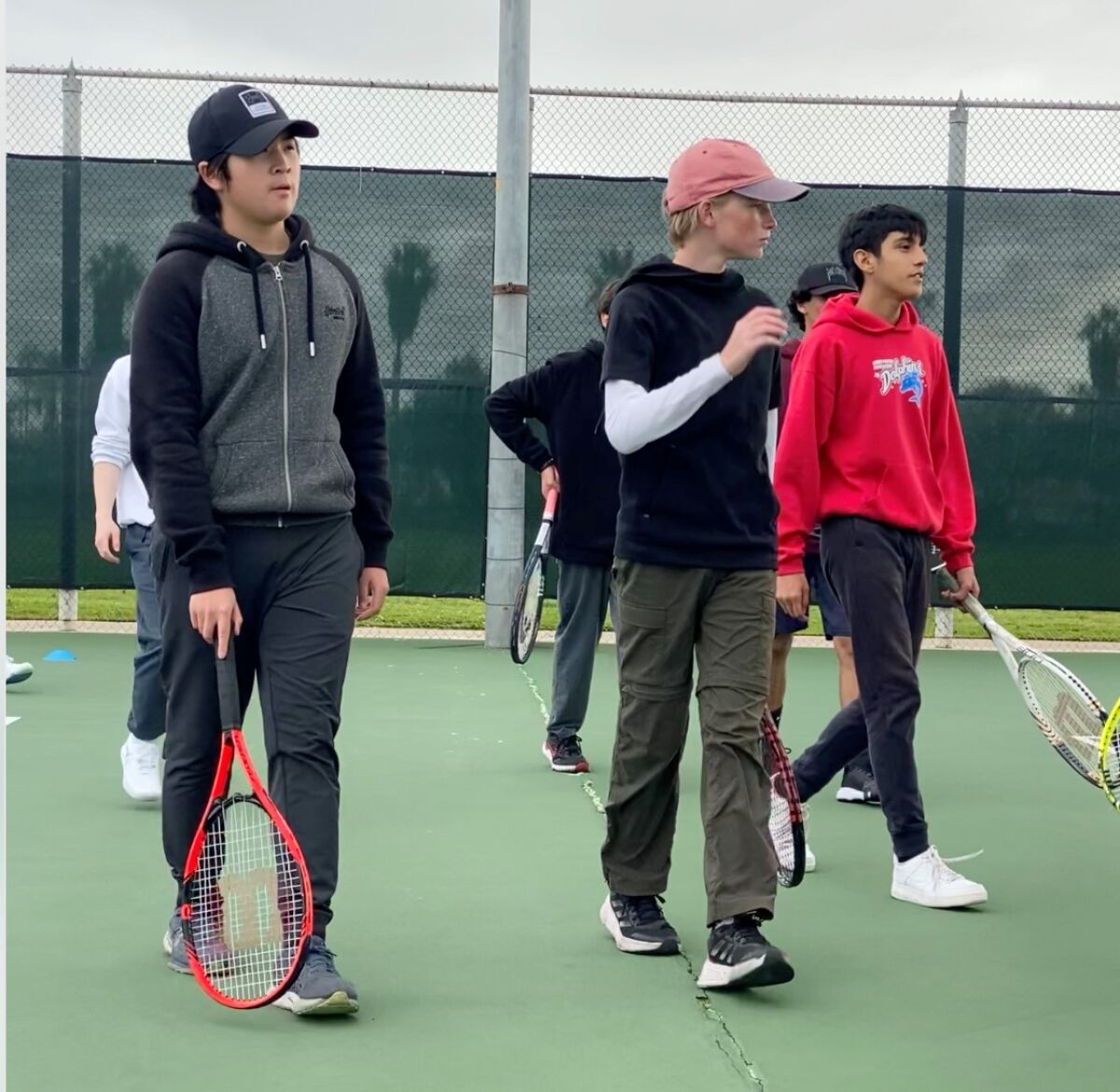 The Point Loma High School boys tennis team takes to the Peninsula Tennis Club courts for an early-morning practice session.