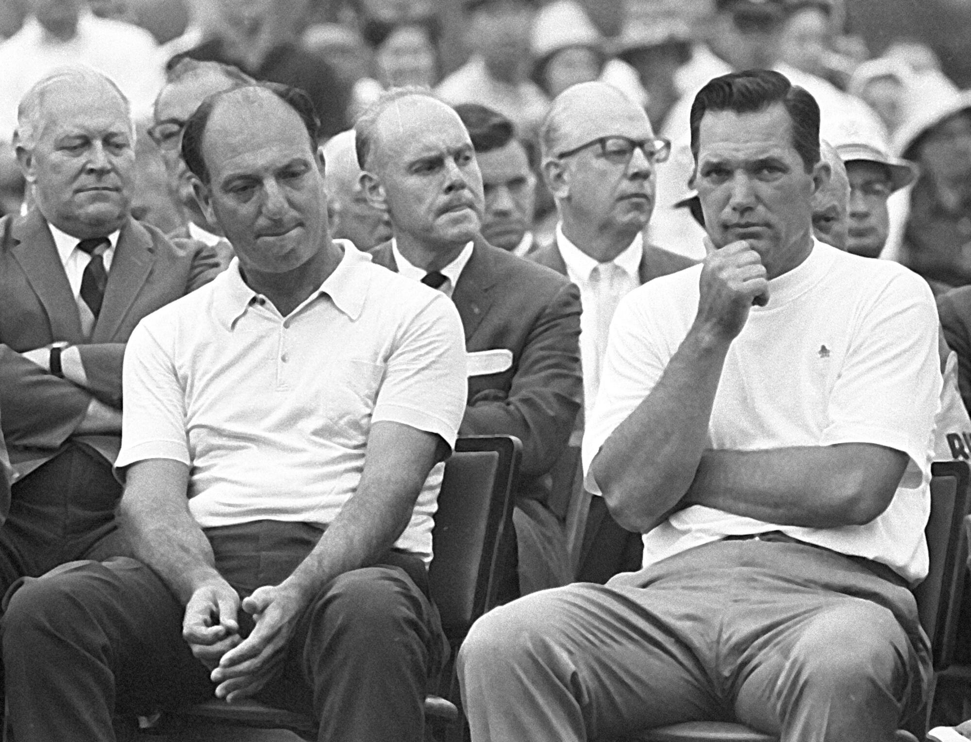 Roberto de Vicenzo sits beside Masters winner Bob Goalby in a black and white photo