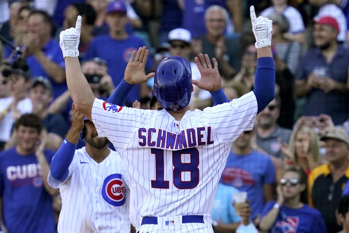 Chicago Cubs' Frank Schwindel (18) celebrates after hitting a grand slam during the seventh inning of a baseball game against the Pittsburgh Pirates in Chicago, Sunday, Sept. 5, 2021. (AP Photo/Nam Y. Huh)