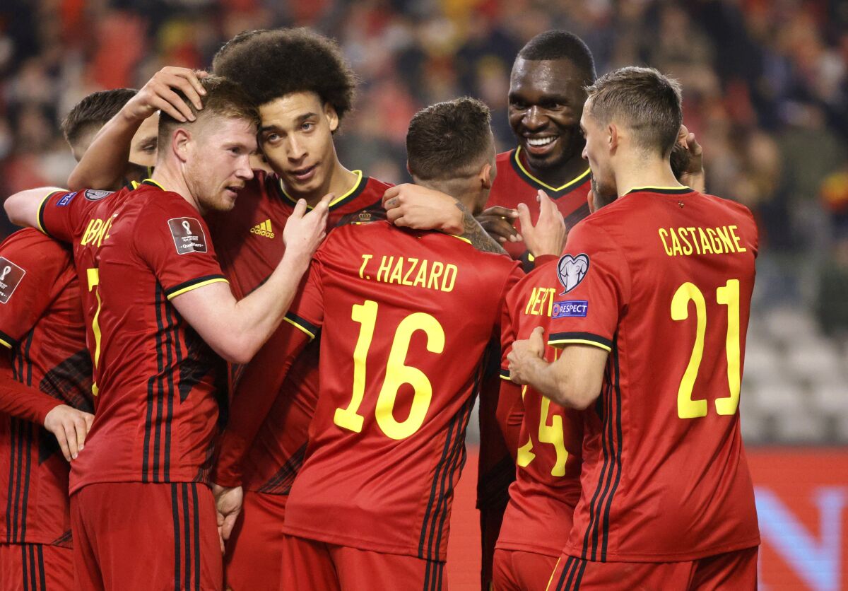 Belgium's Thorgan Hazard, center, is congratulated after scoring his sides third goal during the World Cup 2022 group E qualifying soccer match between Belgium and Estonia at the King Baudouin stadium in Brussels, Saturday, Nov. 13, 2021. (AP Photo/Olivier Matthys)